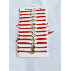 Брослет-оберіг червона нитка з різними кулонами